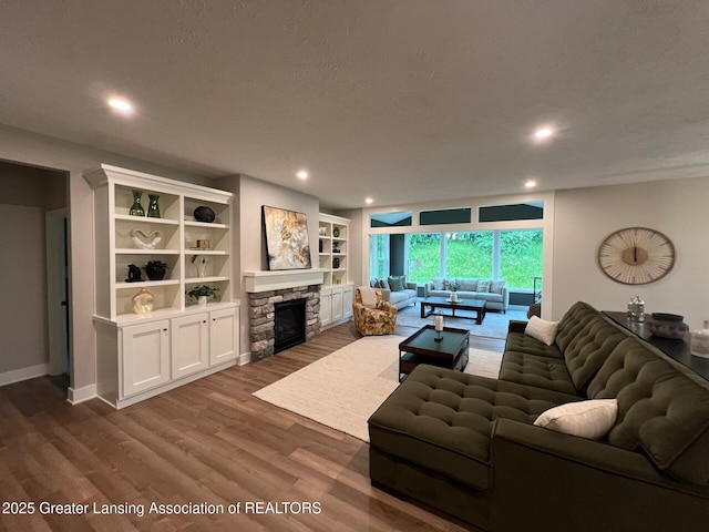 6097 Southridge Rd, East Lansing, MI 48823 - living area featuring a fireplace, dark wood-style floors, and recessed lighting