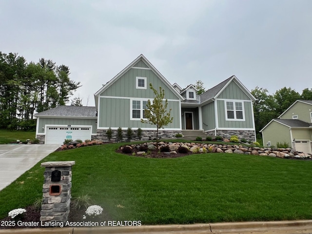 6097 Southridge Rd, East Lansing, MI 48823 - craftsman house with board and batten siding, stone siding, concrete driveway, and a front yard