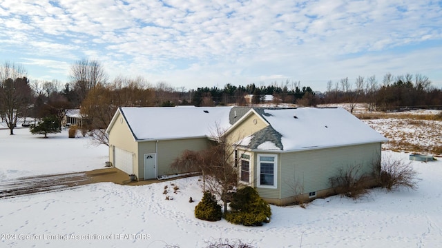 view of snow covered rear of property