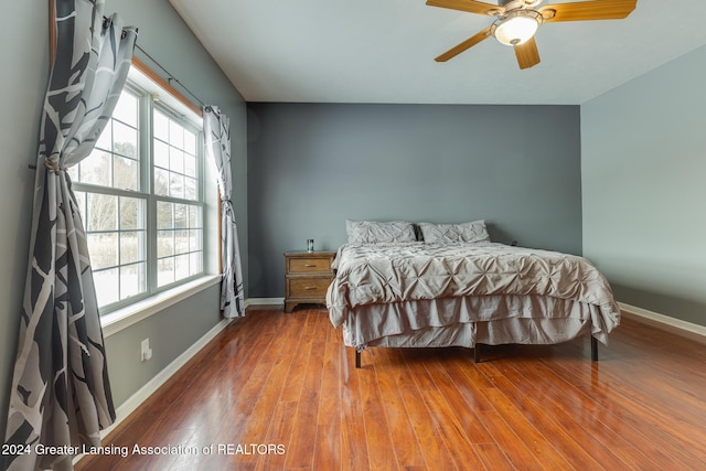 bedroom with ceiling fan and wood-type flooring