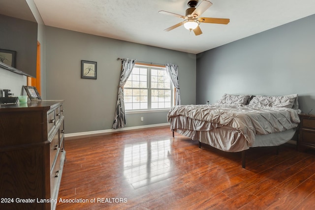 bedroom featuring ceiling fan and dark wood-type flooring