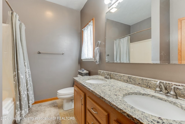 bathroom featuring toilet, vanity, and tile patterned flooring