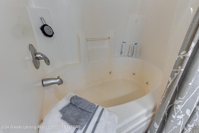 bathroom with shower / bathtub combination with curtain