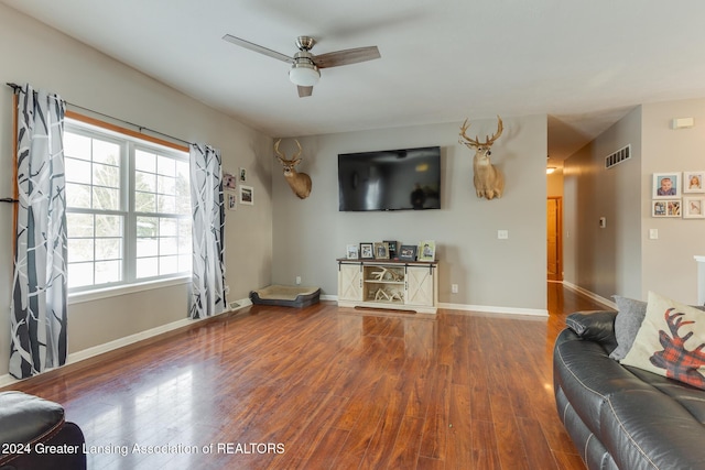 living room featuring ceiling fan and wood-type flooring