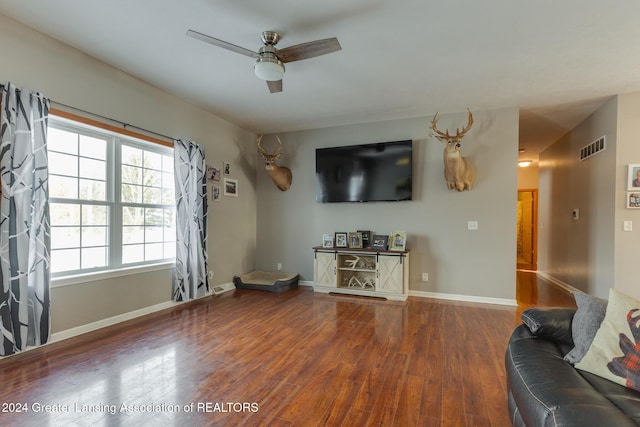 unfurnished living room with dark hardwood / wood-style floors and ceiling fan