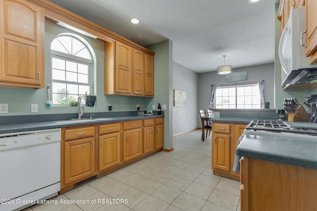 kitchen with decorative light fixtures, sink, white appliances, and light tile patterned flooring