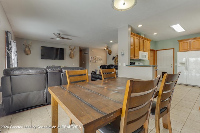 tiled dining area with ceiling fan