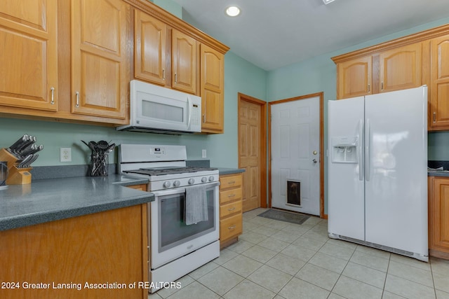 kitchen featuring white appliances and light tile patterned flooring