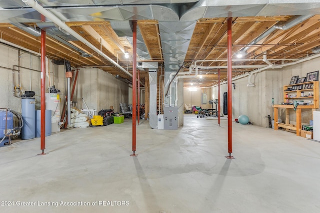 basement featuring heating unit and gas water heater