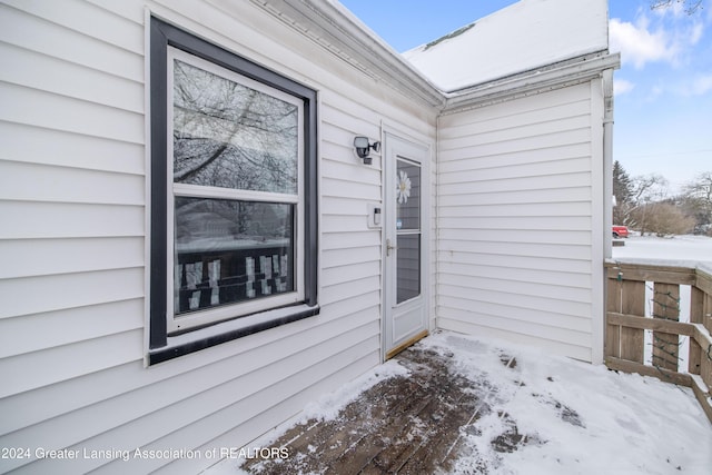 view of snow covered property entrance