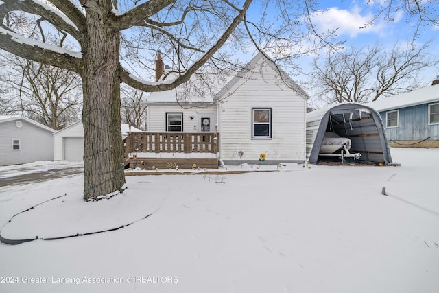 view of front of house featuring a carport, an outbuilding, and a garage