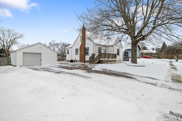 view of front of house with a garage, an outbuilding, and a deck