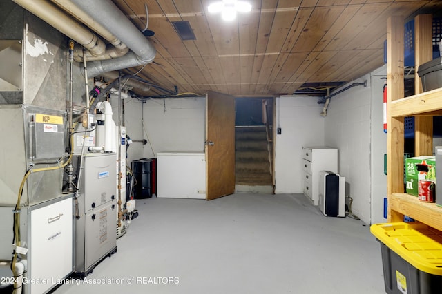 basement featuring refrigerator and wood ceiling