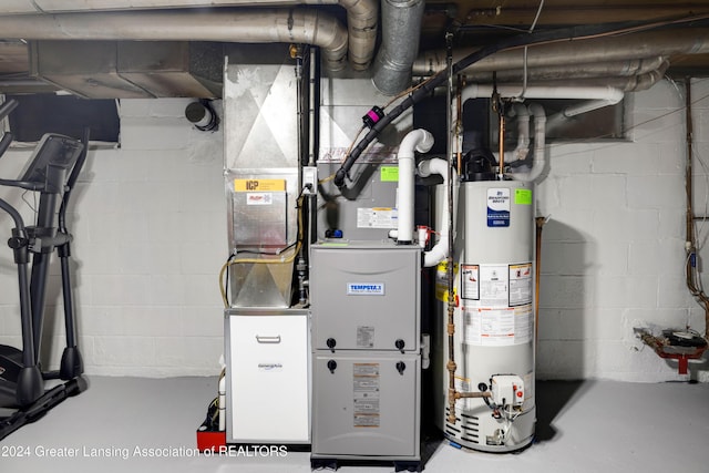 utility room with heating unit and gas water heater