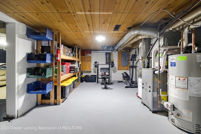 basement featuring electric panel, wooden ceiling, and water heater