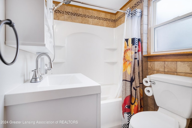 full bathroom with shower / bath combo with shower curtain, toilet, and vanity