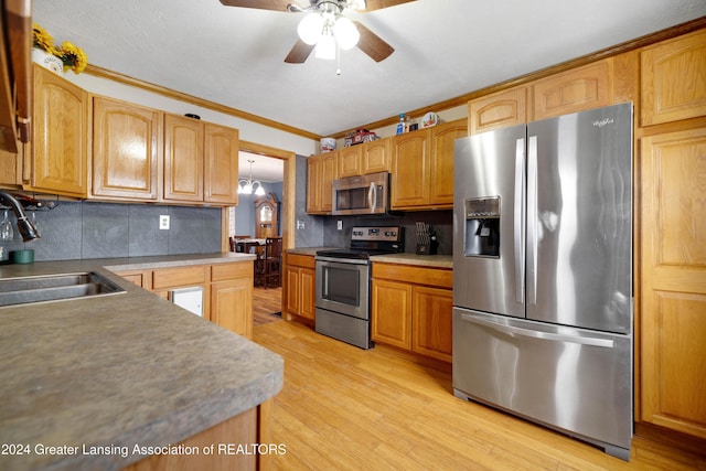 kitchen featuring stainless steel appliances, sink, backsplash, ornamental molding, and light hardwood / wood-style flooring