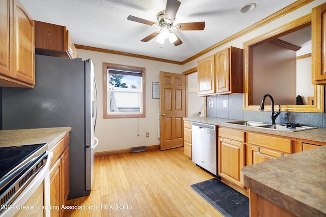 kitchen featuring dishwasher, ceiling fan, sink, ornamental molding, and light hardwood / wood-style floors