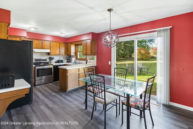 kitchen with sink, a chandelier, dark hardwood / wood-style floors, pendant lighting, and black appliances