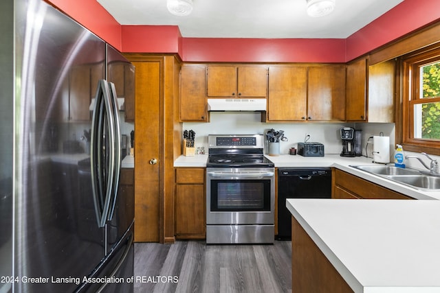 kitchen featuring dark hardwood / wood-style flooring, sink, and stainless steel appliances