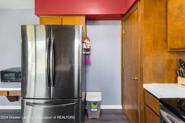 kitchen featuring dark wood-type flooring and stainless steel fridge