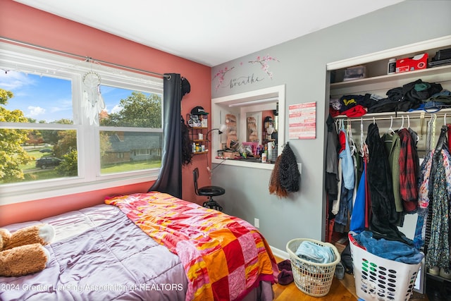 bedroom with hardwood / wood-style flooring and a closet