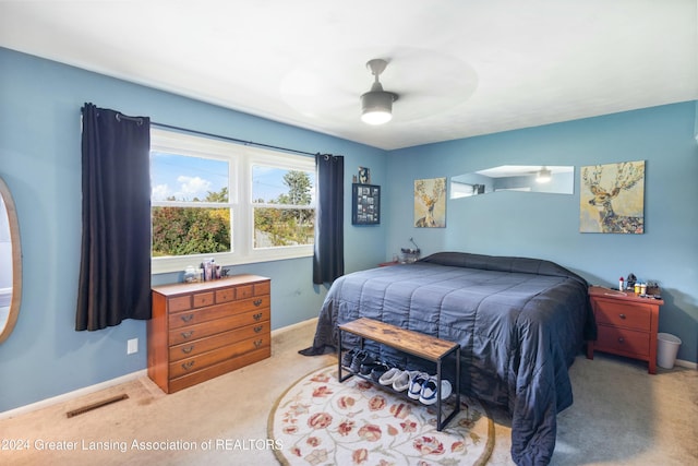 bedroom with ceiling fan and light carpet