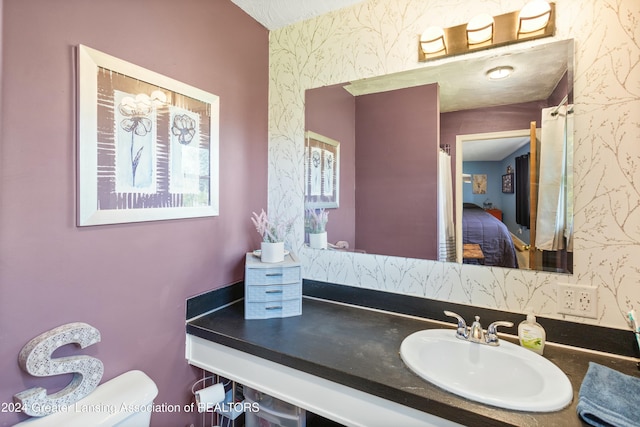 bathroom featuring vanity and toilet