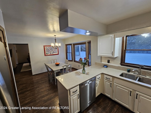 kitchen featuring kitchen peninsula, stainless steel dishwasher, pendant lighting, sink, and white cabinetry