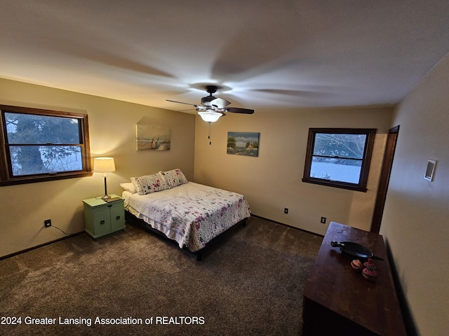 bedroom with ceiling fan and dark carpet