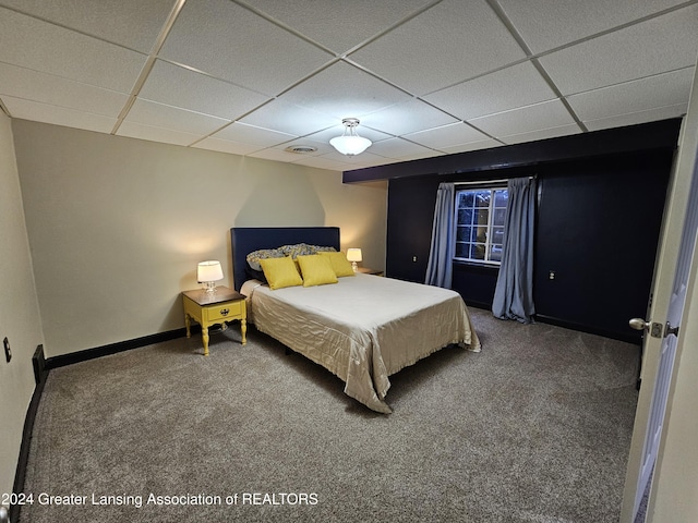 bedroom with carpet and a paneled ceiling