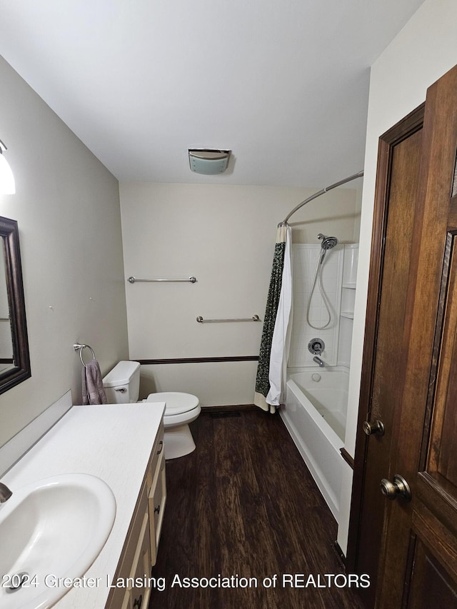 full bathroom with vanity, toilet, hardwood / wood-style floors, and shower / bathtub combination with curtain