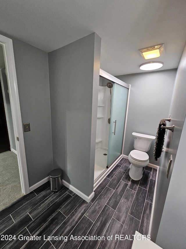 bathroom with toilet and walk in shower