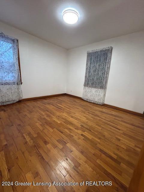 empty room featuring baseboards and wood finished floors