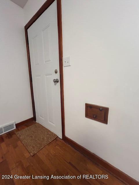 interior space with visible vents, baseboards, and wood finished floors