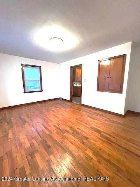 unfurnished room featuring wood finished floors and baseboards