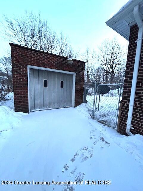 snow covered structure with a gate