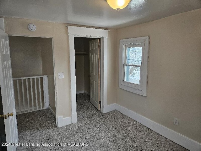 unfurnished bedroom featuring a closet and carpet flooring