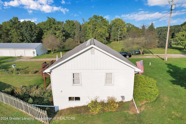 view of side of home with a yard