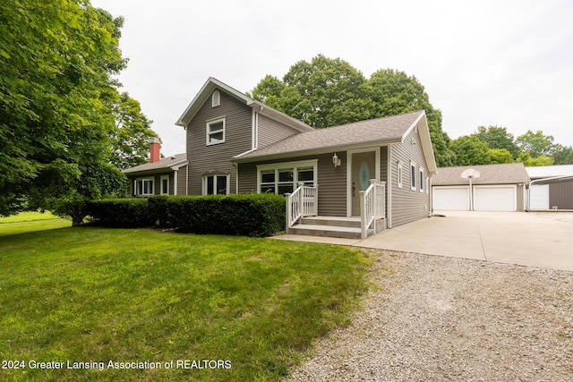 view of front of house with a garage and a front lawn