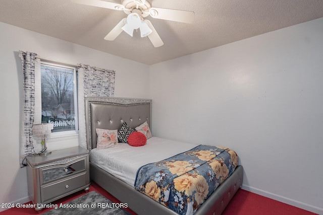 bedroom with ceiling fan and a textured ceiling