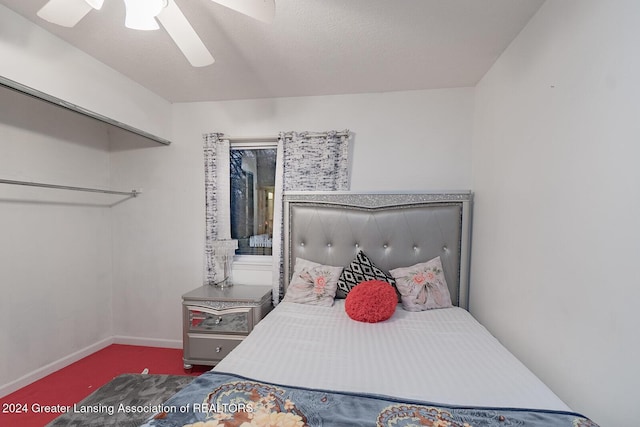 carpeted bedroom featuring ceiling fan and a closet