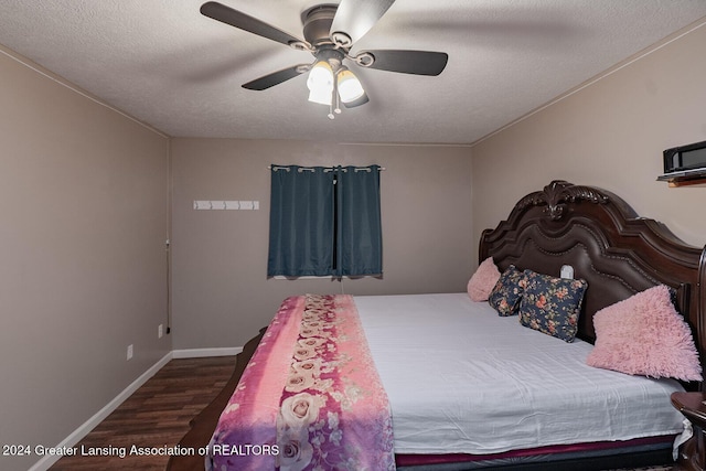 bedroom with ceiling fan, dark hardwood / wood-style floors, and a textured ceiling