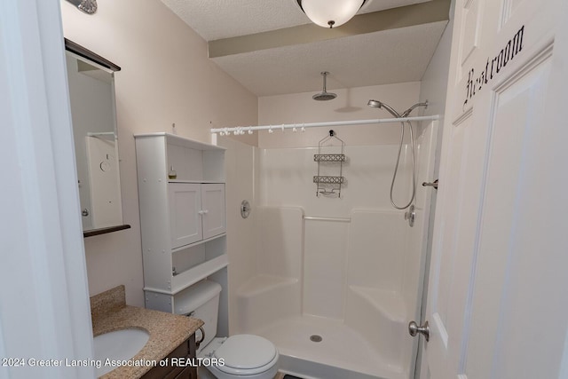 bathroom with a shower, a textured ceiling, toilet, and vanity