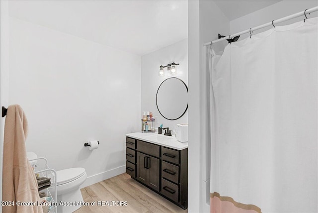 bathroom featuring hardwood / wood-style floors, toilet, and vanity