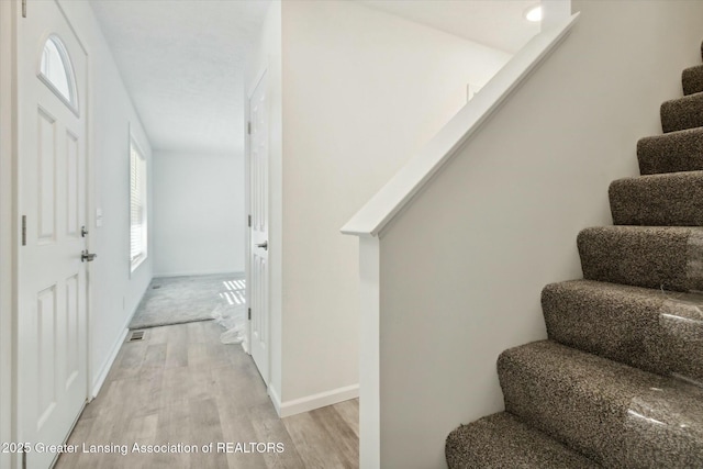 stairs with wood-type flooring