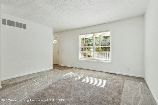 empty room featuring a textured ceiling