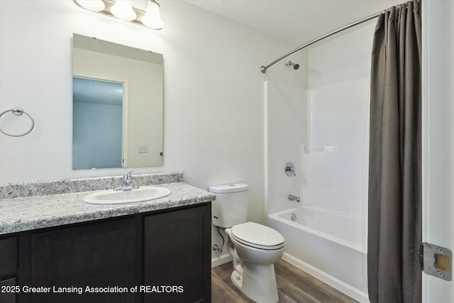 full bathroom with wood-type flooring, shower / bath combo, vanity, and toilet