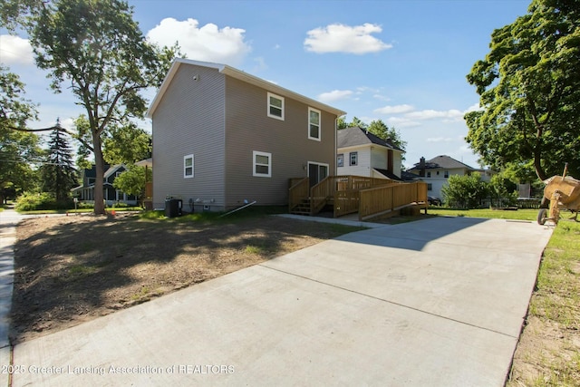 view of property exterior with a wooden deck