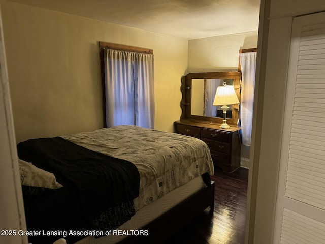 bedroom with dark wood finished floors